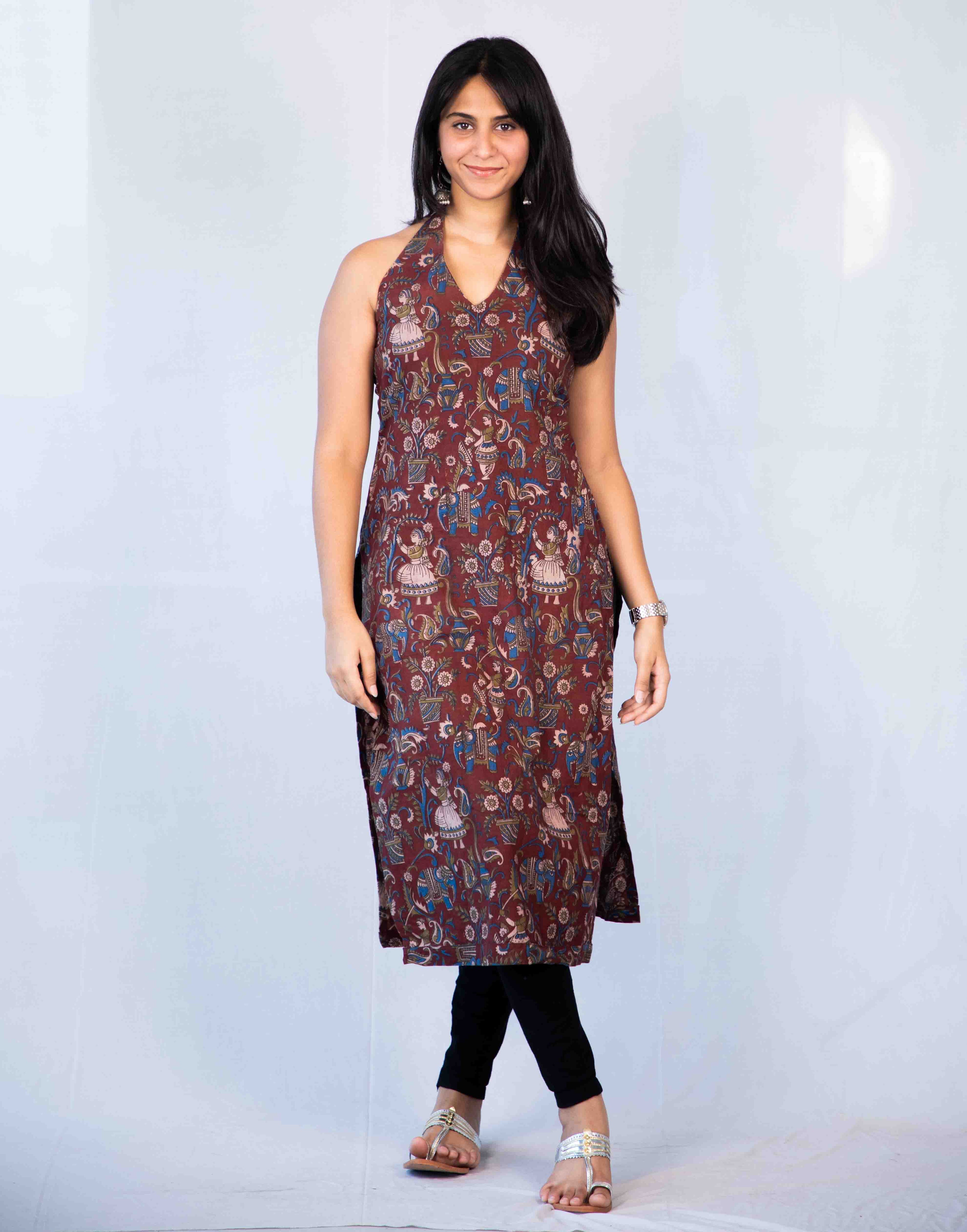 Woman wearing a patterned dress on a white background